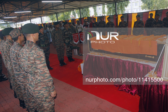 Indian ARMY personnel are paying respect in front of the coffin of martyred Army captain Brijesh Thapa, a resident of Darjeeling who was kil...