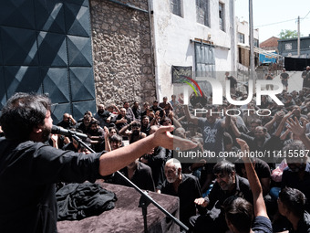 Shiite Muslim mourners are taking part in a religious procession on the tenth day of Ashura in the Islamic month of Muharram in Pireaus, Gre...