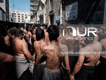 Shiite Muslim mourners are taking part in a religious procession on the tenth day of Ashura in the Islamic month of Muharram in Pireaus, Gre...