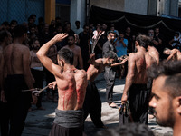 Shiite Muslims are flagellating themselves during a religious procession to mark Ashura in Pireaus, Greece, on July 17, 2024. The mourning o...