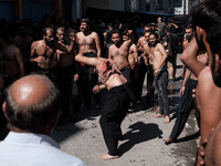 Shiite Muslims are flagellating themselves during a religious procession to mark Ashura in Pireaus, Greece, on July 17, 2024. The mourning o...