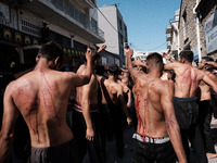 Shiite Muslims are flagellating themselves during a religious procession to mark Ashura in Pireaus, Greece, on July 17, 2024. The mourning o...