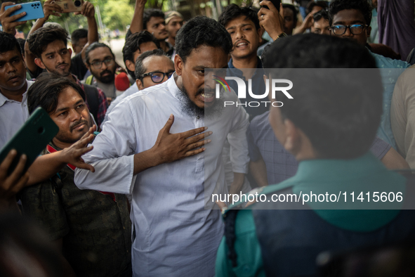 A man is arguing with police as he is not leaving the University of Dhaka premises, a day after the clash between Bangladesh Chhatra League,...