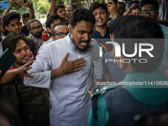 A man is arguing with police as he is not leaving the University of Dhaka premises, a day after the clash between Bangladesh Chhatra League,...