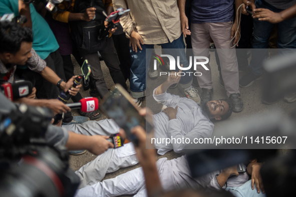 A man is arguing with police as he is not leaving the University of Dhaka premises, a day after the clash between Bangladesh Chhatra League,...