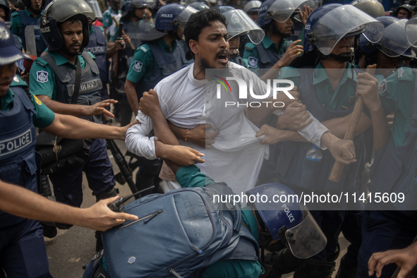 Police are detaining a man who is not leaving the University of Dhaka premises, a day after the clash between Bangladesh Chhatra League, the...