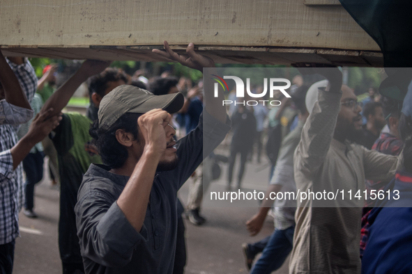 Anti-quota protesters are marching with a dummy coffin at the University of Dhaka, remembering those who are dying yesterday during the clas...