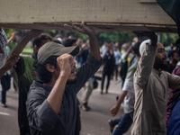 Anti-quota protesters are marching with a dummy coffin at the University of Dhaka, remembering those who are dying yesterday during the clas...