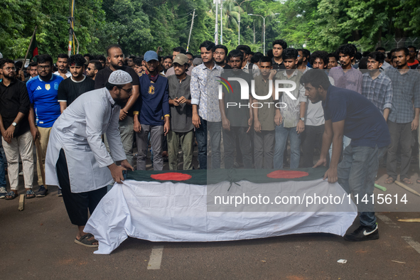 Anti-quota protesters are joining in a funeral prayer with a dummy coffin at the University of Dhaka, remembering those who are dying yester...