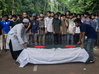 Anti-quota protesters are joining in a funeral prayer with a dummy coffin at the University of Dhaka, remembering those who are dying yester...