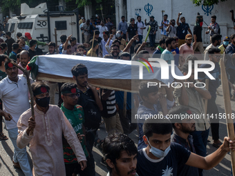 Anti-quota protesters are marching with a dummy coffin at the University of Dhaka, remembering those who are dying yesterday during the clas...