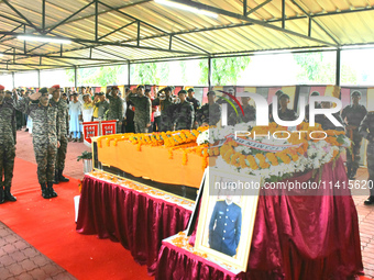 Indian ARMY personnel are paying respect in front of the coffin of martyred Army captain Brijesh Thapa, a resident of Darjeeling, who was ki...