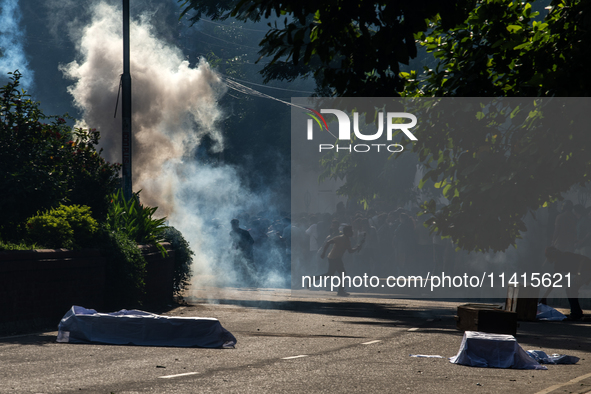 People are running as police are firing teargas during a coffin rally of anti-quota protesters at the University of Dhaka, a day after the c...