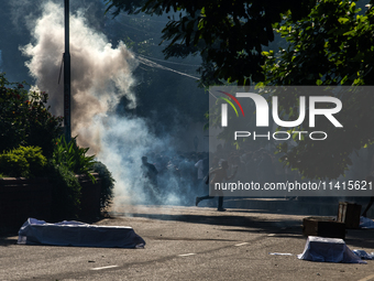 People are running as police are firing teargas during a coffin rally of anti-quota protesters at the University of Dhaka, a day after the c...