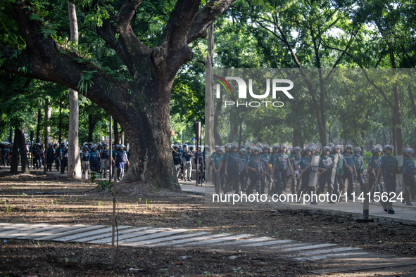 Police are walking towards the halls of the University of Dhaka after the dummy coffin rally, a day after the clash with Bangladesh Chhatra...