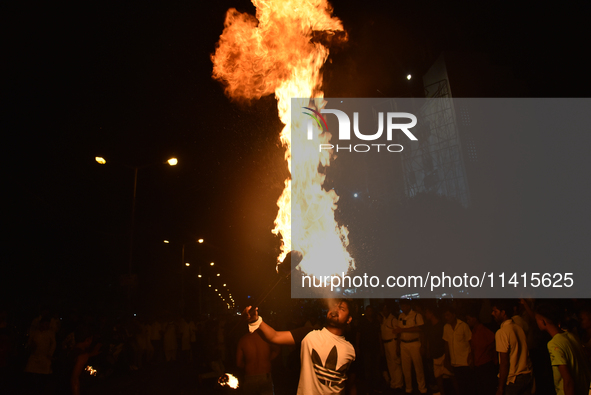 An Indian Muslim is blowing fire during the Muharram festival in Kolkata, India, on July 17, 2024. 