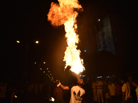 An Indian Muslim is blowing fire during the Muharram festival in Kolkata, India, on July 17, 2024. (