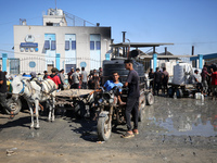 Palestinians are filling containers with water at a desalination plant in Deir el-Balah in the central Gaza Strip on July 17, 2024, amid the...