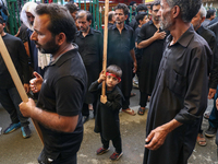 A Kashmiri Shia Muslim kid is participating in the Ashura procession in Srinagar, Indian Administered Kashmir, on July 17, 2024. (