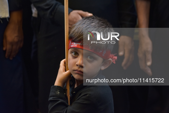 A Kashmiri Shia Muslim kid is participating in the Ashura procession in Srinagar, Indian Administered Kashmir, on July 17, 2024. 