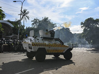 Bangladesh police personnel are firing tear shells as students are protesting against quotas in government jobs alongside symbolic coffins o...