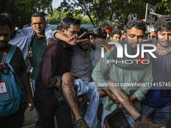 A student is being injured after police are firing rubber bullets to disperse anti-quota student protesters at the Dhaka University area, in...