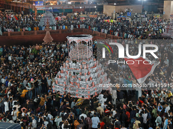 Indian Muslims are carrying 'Tazias' as they are taking part in a Muharram procession in Jaipur, Rajasthan, India, on July 17, 2024. During...