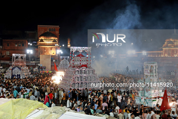 Indian Muslims are carrying 'Tazias' as they are taking part in a Muharram procession in Jaipur, Rajasthan, India, on July 17, 2024. During...