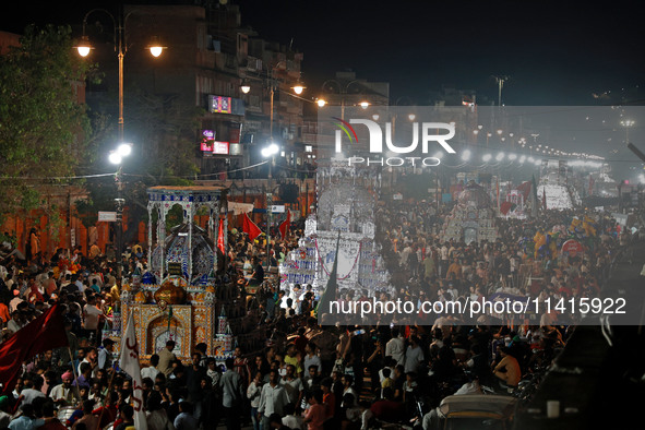 Indian Muslims are carrying 'Tazias' as they are taking part in a Muharram procession in Jaipur, Rajasthan, India, on July 17, 2024. During...