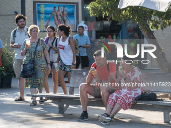 People are spending the afternoon in the city center at the gates of the first heat wave on the Iberian Peninsula, in Barcelona, Spain, on J...