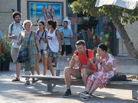 People are spending the afternoon in the city center at the gates of the first heat wave on the Iberian Peninsula, in Barcelona, Spain, on J...