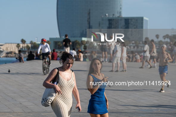 People are spending the afternoon in the city center at the gates of the first heat wave on the Iberian Peninsula, in Barcelona, Spain, on J...