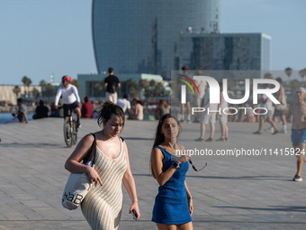 People are spending the afternoon in the city center at the gates of the first heat wave on the Iberian Peninsula, in Barcelona, Spain, on J...