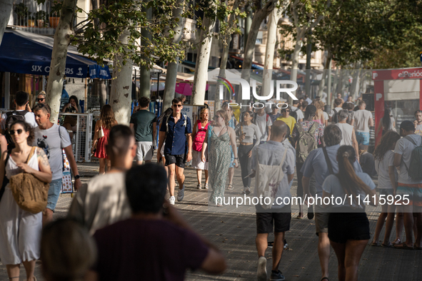 People are spending the afternoon in the city center at the gates of the first heat wave on the Iberian Peninsula, in Barcelona, Spain, on J...