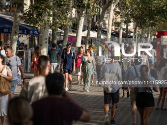 People are spending the afternoon in the city center at the gates of the first heat wave on the Iberian Peninsula, in Barcelona, Spain, on J...