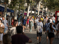 People are spending the afternoon in the city center at the gates of the first heat wave on the Iberian Peninsula, in Barcelona, Spain, on J...