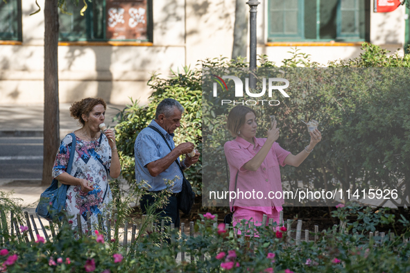 People are spending the afternoon in the city center at the gates of the first heat wave on the Iberian Peninsula, in Barcelona, Spain, on J...