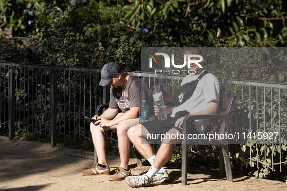 People are spending the afternoon in the city center at the gates of the first heat wave on the Iberian Peninsula, in Barcelona, Spain, on J...