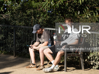 People are spending the afternoon in the city center at the gates of the first heat wave on the Iberian Peninsula, in Barcelona, Spain, on J...