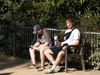 People are spending the afternoon in the city center at the gates of the first heat wave on the Iberian Peninsula, in Barcelona, Spain, on J...