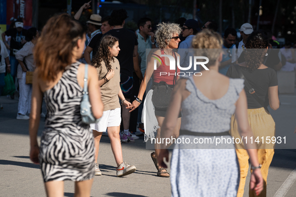 People are spending the afternoon in the city center at the gates of the first heat wave on the Iberian Peninsula, in Barcelona, Spain, on J...