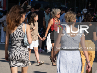 People are spending the afternoon in the city center at the gates of the first heat wave on the Iberian Peninsula, in Barcelona, Spain, on J...