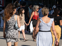 People are spending the afternoon in the city center at the gates of the first heat wave on the Iberian Peninsula, in Barcelona, Spain, on J...