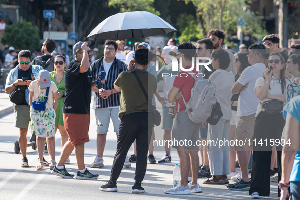 People are spending the afternoon in the city center at the gates of the first heat wave on the Iberian Peninsula, in Barcelona, Spain, on J...