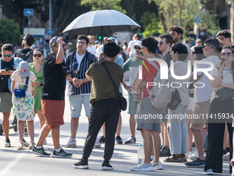 People are spending the afternoon in the city center at the gates of the first heat wave on the Iberian Peninsula, in Barcelona, Spain, on J...