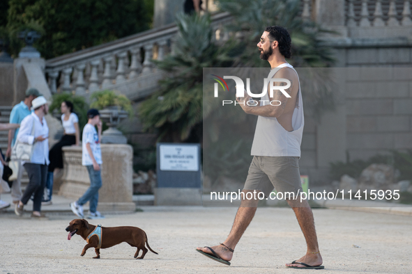 People are spending the afternoon in the city center at the gates of the first heat wave on the Iberian Peninsula, in Barcelona, Spain, on J...