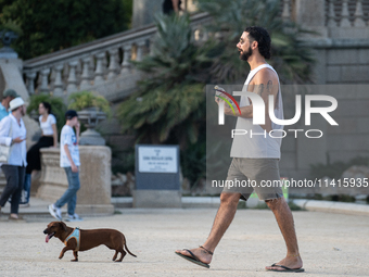 People are spending the afternoon in the city center at the gates of the first heat wave on the Iberian Peninsula, in Barcelona, Spain, on J...