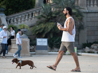 People are spending the afternoon in the city center at the gates of the first heat wave on the Iberian Peninsula, in Barcelona, Spain, on J...