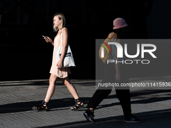 People are spending the afternoon in the city center at the gates of the first heat wave on the Iberian Peninsula, in Barcelona, Spain, on J...