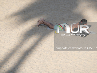 People are spending the afternoon in the city center at the gates of the first heat wave on the Iberian Peninsula, in Barcelona, Spain, on J...